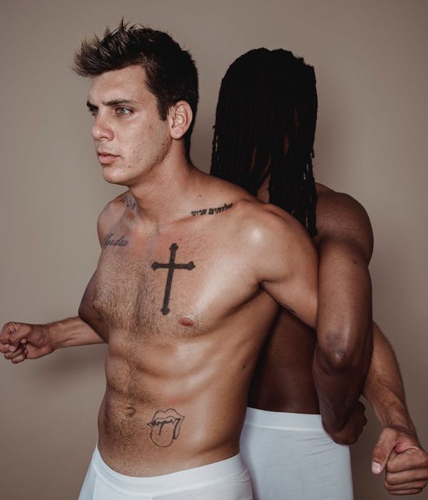 A fit man performing a powerful strength exercise in a dark, minimalist gym.